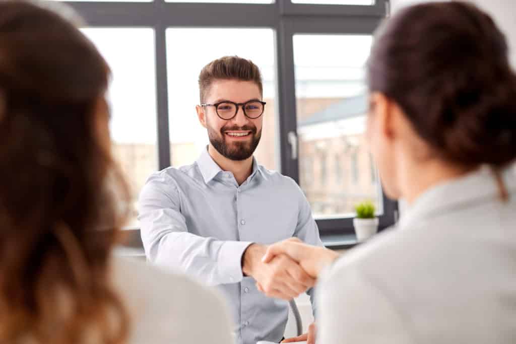 A mana nd woman doing a handshake to seal a business deal